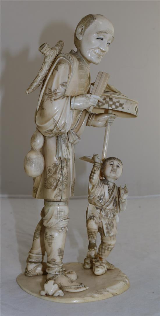 A large sectional ivory group of man and a boy, early 20th century, 30.5cm